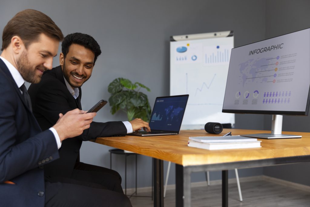 businessmen looking at a laptop